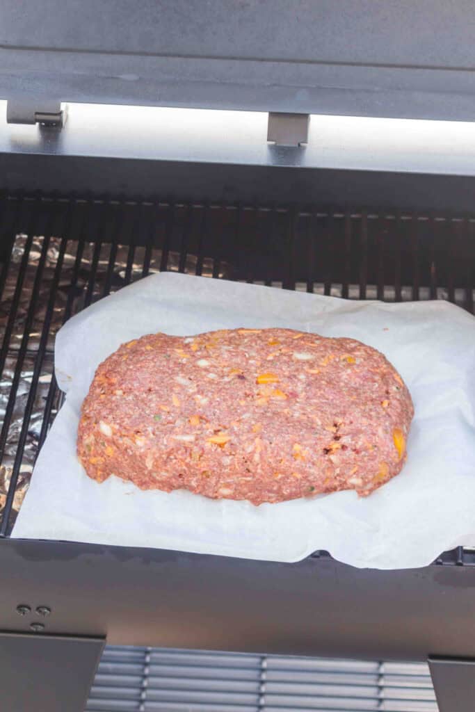 Raw Smoked Cowboy Meatloaf on parchment paper inside the smoker