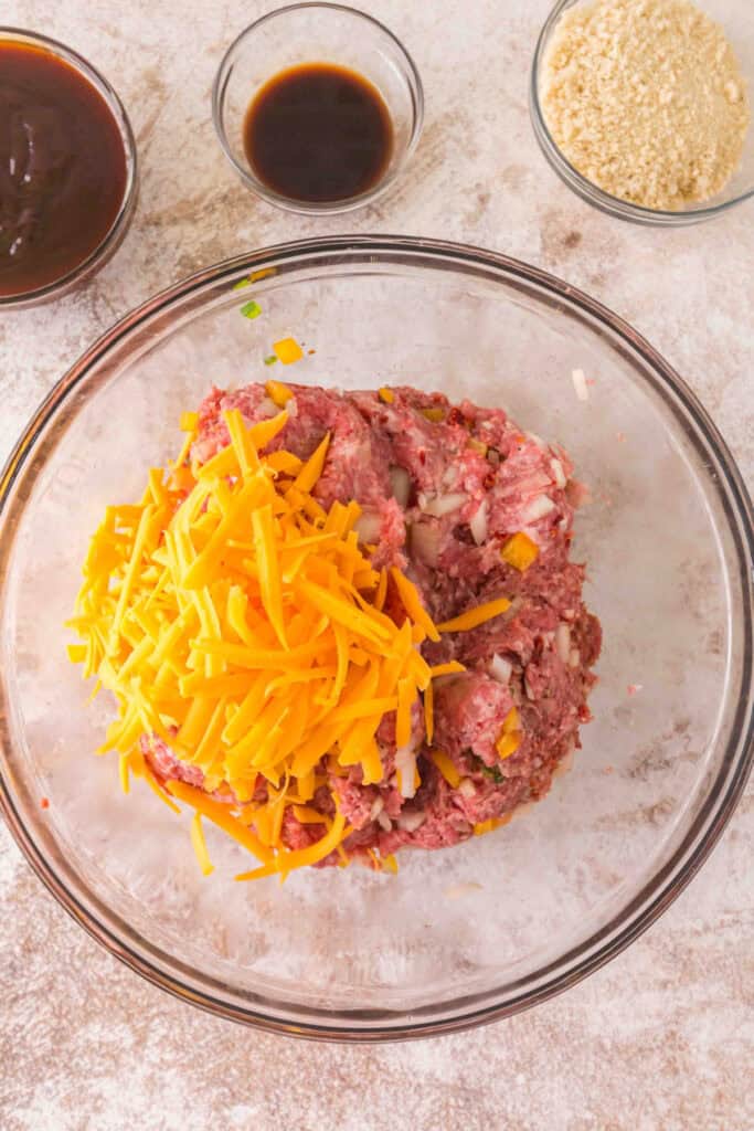 Ground meat mixture topped with shredded cheddar cheese