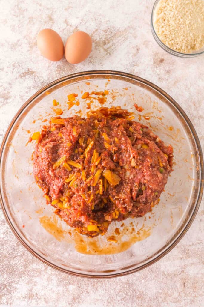 Ground meat mixture combined with chopped peppers, onions, cheese, sauces, and seasonings
