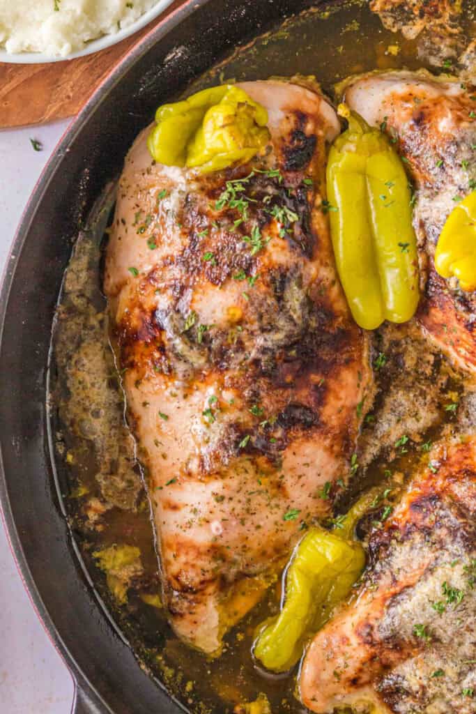Smoked Mississippi Chicken with browned chicken breasts, pepperoncini, and buttery cooking juices