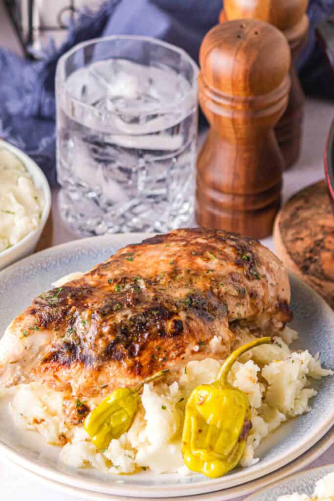 Smoked chicken breast served over mashed potatoes with roasted pepperoncini