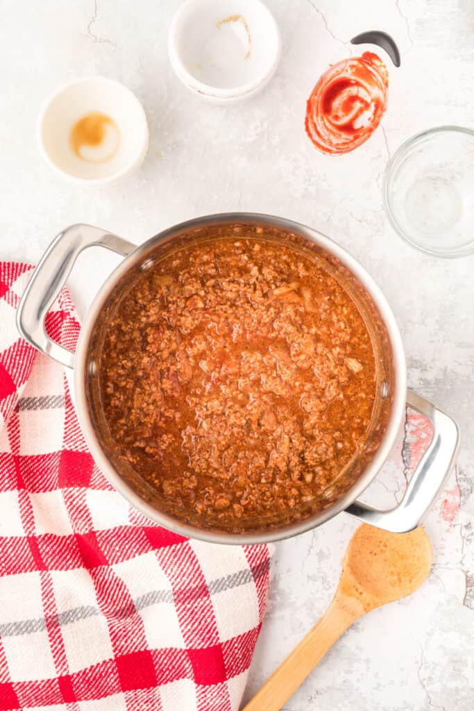 Southern Style Hot Dog Chili simmering in a saucepan until thick and rich.