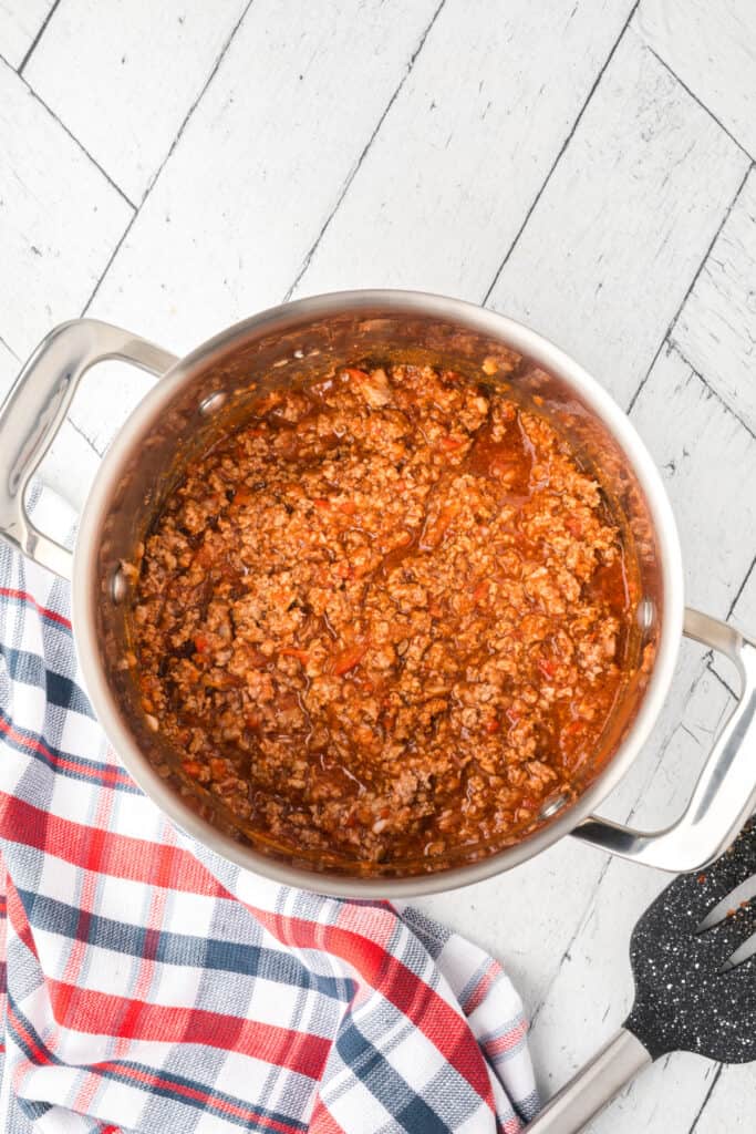 Homemade ground beef chili cooked in a pot for Texas Chili Dogs