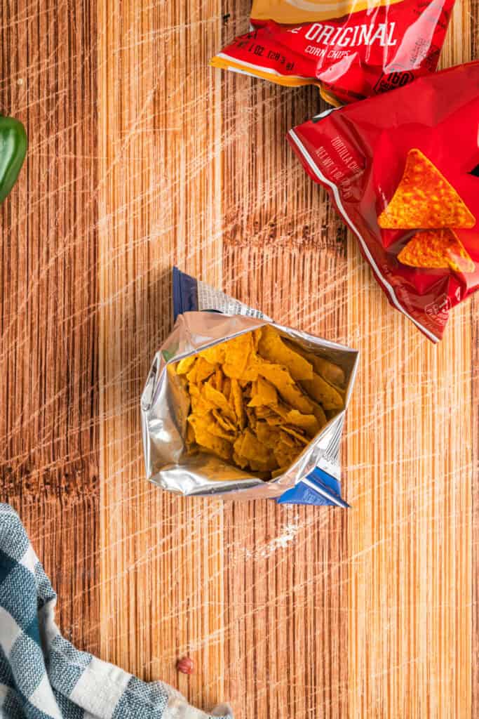 Open bag of crushed corn chips ready to be filled with taco meat and toppings