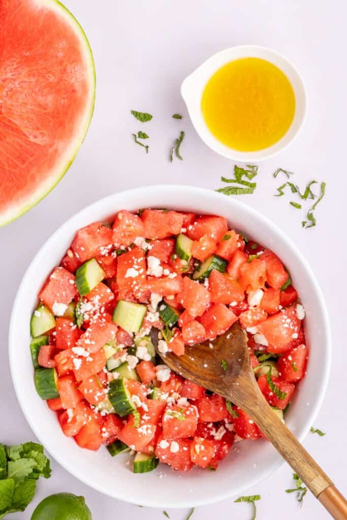 Overhead view of fresh Watermelon Feta Mint Salad with cucumber, feta cheese, and mint.