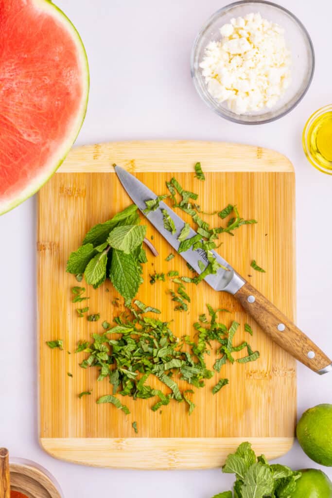 Fresh mint leaves sliced into thin ribbons for Watermelon Feta Mint Salad.