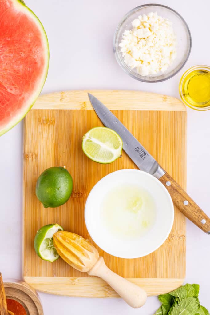 Fresh lime juice squeezed into a bowl for the honey lime dressing.