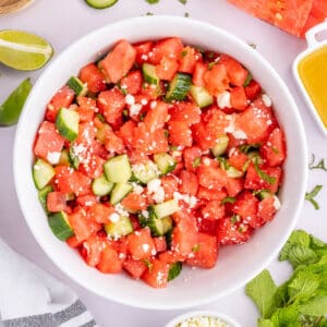 Square overhead photo of Watermelon Feta Mint Salad with juicy watermelon, cucumber, feta cheese, and fresh mint.