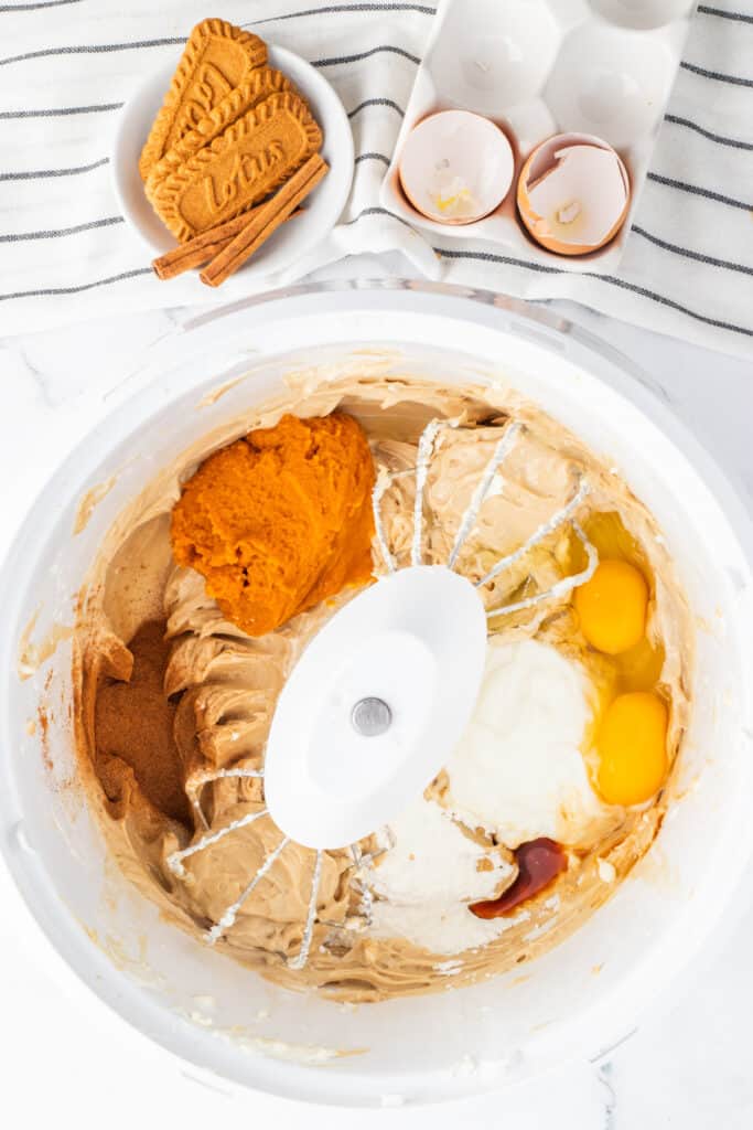 Pumpkin puree, eggs, Greek yogurt, spices, vanilla, and cornstarch added to the cream cheese mixture.