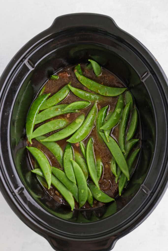 Fresh snap peas added to the slow cooker with the tender Asian pot roast