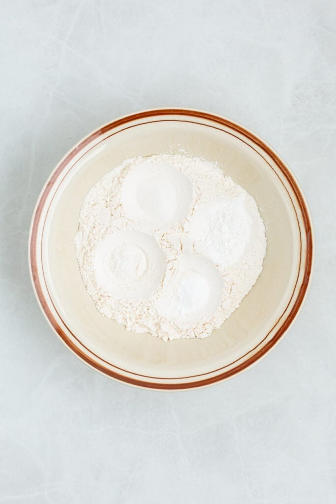 Flour mixture for sour cream biscuits in a large mixing bowl.