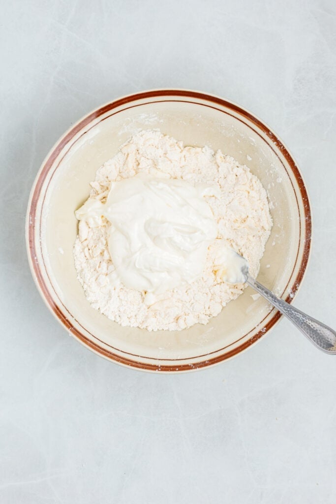 Sour cream added to the flour and butter mixture for air fryer biscuits.