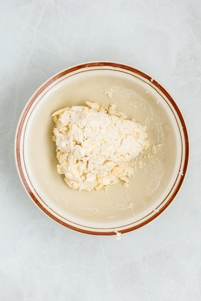 Sour cream biscuit dough turned out onto a lightly floured work surface.