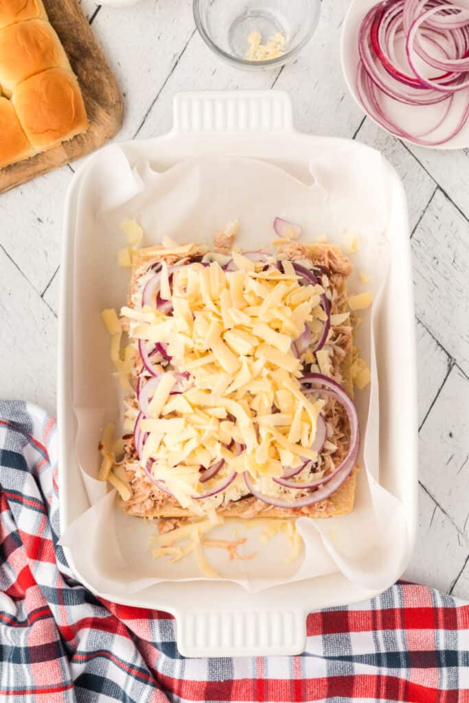 Shredded smoked gouda added over red onion and BBQ chicken slider filling.