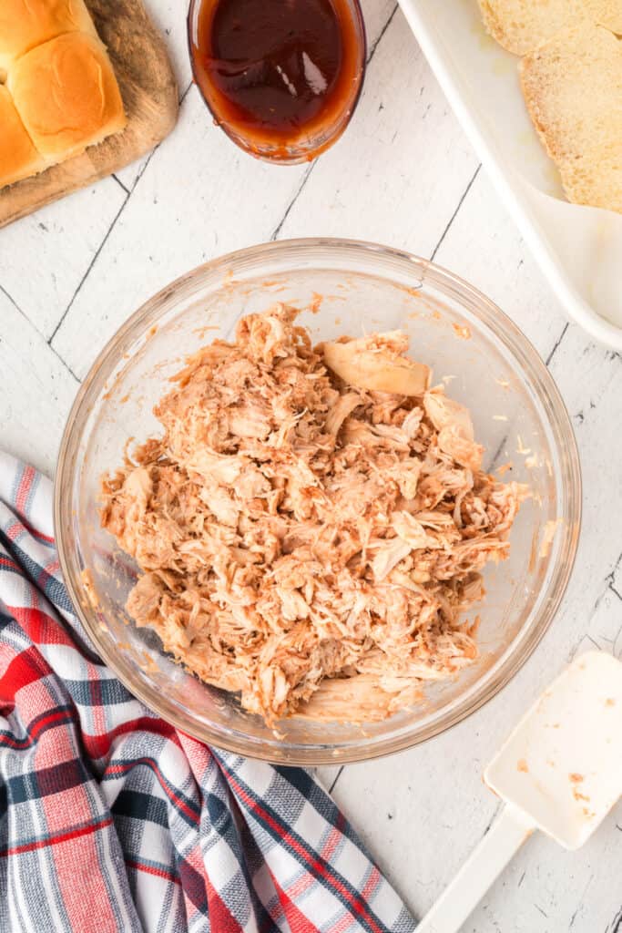 Shredded chicken mixed with BBQ sauce and ready for assembling the sliders.
