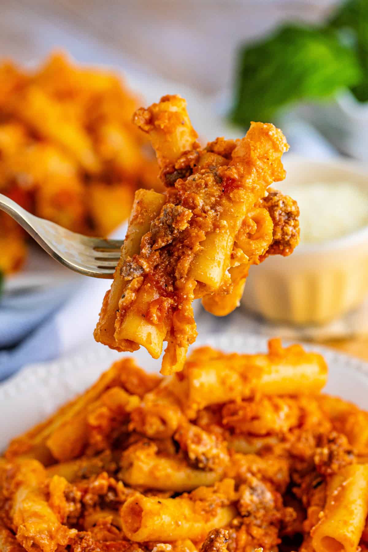 Serving of cheesy baked ziti with pasta and meat sauce