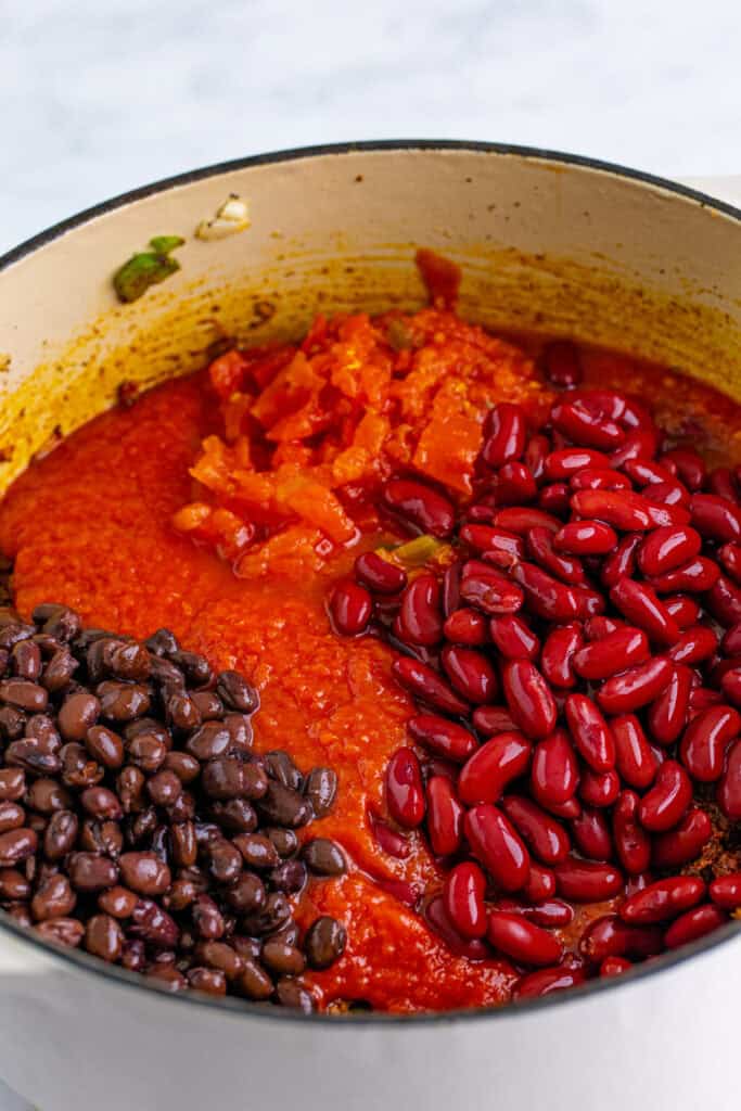Tomatoes, black beans, and kidney beans added to the seasoned ground beef mixture