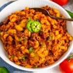 Cheesy Chili Mac with ground beef, kidney beans, black beans, elbow macaroni, and sliced jalapeño