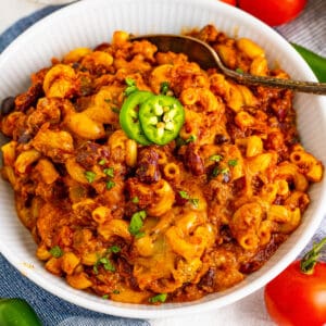 Cheesy Chili Mac with ground beef, kidney beans, black beans, elbow macaroni, and sliced jalapeño