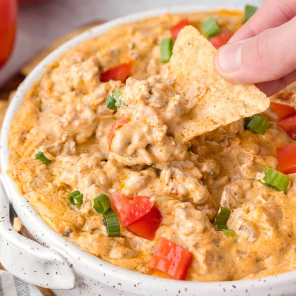 Creamy Hamburger Dip with seasoned ground beef, Rotel tomatoes, and melted cheese, ready to serve with chips.