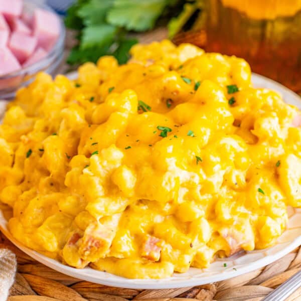 A serving of creamy macaroni and cheese with diced ham.