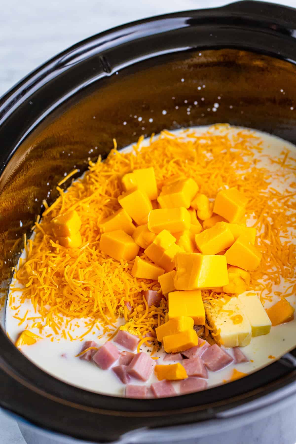 Step 1 of making slow cooker ham mac and cheese.