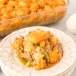 Breakfast tater tot casserole with sausage, eggs, and melted Colby Jack cheese